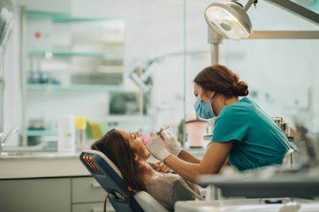 Dentist performing a detailed oral examination on a patient at Enbite Dental Studio